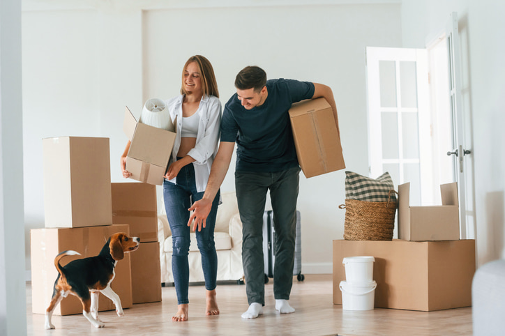Couple moving with their dog